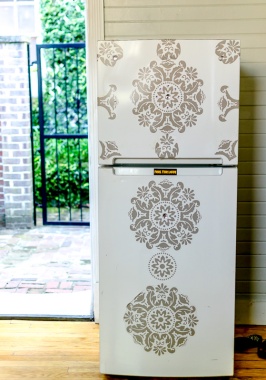 Fridge with a graphic and bedazzled print.